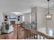 Upper level view of the living room featuring a cozy fireplace and comfortable seating at 827 River Hills Ct, Taylorsville, NC 28681