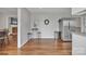 Spacious living area with stainless refrigerator, island with seating, and hardwood floors at 827 River Hills Ct, Taylorsville, NC 28681