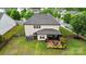 Aerial view of the backyard featuring a patio with a fire pit and landscaped yard at 9530 Hightower Oak St, Huntersville, NC 28078
