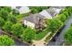 An aerial view of a beautiful two-story house with lush landscaping and mature trees in a neighborhood at 9530 Hightower Oak St, Huntersville, NC 28078