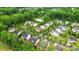 An aerial view of a neighborhood of single Gathering homes interspersed with lush green trees at 9530 Hightower Oak St, Huntersville, NC 28078