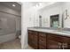 Bathroom featuring double vanity with granite countertops and a shower-tub combo at 9530 Hightower Oak St, Huntersville, NC 28078