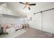 Stylized bedroom with a bed, sofa, and a barn door at 9530 Hightower Oak St, Huntersville, NC 28078
