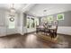 Elegant dining room with wood floors, stylish lighting, and plenty of natural light from large windows at 9530 Hightower Oak St, Huntersville, NC 28078