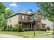 Beautiful two-story home with brick and siding, complemented by lush landscaping and mature trees at 9530 Hightower Oak St, Huntersville, NC 28078