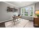 Bright home office with a large window, a wooden desk, a comfortable chair, and stylish decor at 9530 Hightower Oak St, Huntersville, NC 28078