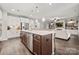Open kitchen with island, stainless steel appliances, and adjoining living area at 9530 Hightower Oak St, Huntersville, NC 28078