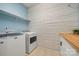 Functional laundry room featuring modern appliances, butcher block countertop, and ample storage at 9530 Hightower Oak St, Huntersville, NC 28078