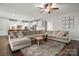 Bright living room with large sectional couch and open view of the kitchen at 9530 Hightower Oak St, Huntersville, NC 28078
