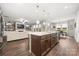 Open floor plan showing living room with fireplace and view of kitchen and dining area at 9530 Hightower Oak St, Huntersville, NC 28078