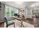 Bright home office space with large windows, hardwood floors, and neutral wall colors at 9530 Hightower Oak St, Huntersville, NC 28078