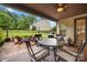 Covered patio with outdoor dining and seating overlooking the backyard at 9530 Hightower Oak St, Huntersville, NC 28078