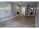 Serene bedroom with neutral paint, carpet, crown molding, and access to attached bathrooms, offering convenience at 1000 E Woodlawn Rd # 107, Charlotte, NC 28209