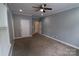 Spacious bedroom with neutral walls, carpeting, ceiling fan, recessed lighting, and access to multiple rooms at 1000 E Woodlawn Rd # 107, Charlotte, NC 28209