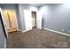 Carpeted bedroom featuring neutral walls, access to a walk-in closet, and a tranquil atmosphere at 1000 E Woodlawn Rd # 107, Charlotte, NC 28209