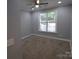 Well-lit bedroom with neutral walls, carpeted flooring, a ceiling fan, and a serene, private atmosphere at 1000 E Woodlawn Rd # 107, Charlotte, NC 28209