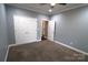 Cozy bedroom featuring neutral walls, carpeting, and a closet, offering a comfortable and organized space at 1000 E Woodlawn Rd # 107, Charlotte, NC 28209