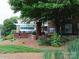 A view of the Preston Flats sign with landscaping at 1000 E Woodlawn Rd # 107, Charlotte, NC 28209