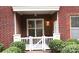 View of the front porch with white fence and seating outside unit 107 at 1000 E Woodlawn Rd # 107, Charlotte, NC 28209