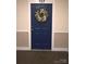 Blue front door #107 is decorated with a cheerful wreath at 1000 E Woodlawn Rd # 107, Charlotte, NC 28209