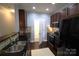 Well-equipped kitchen with stainless steel appliances, a black fridge, and dark cabinets at 1000 E Woodlawn Rd # 107, Charlotte, NC 28209