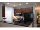 Modern kitchen featuring dark cabinetry, stainless steel appliances, and sleek black countertops at 1000 E Woodlawn Rd # 107, Charlotte, NC 28209