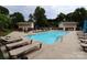 In-ground pool with lounge seating at the community center at 1000 E Woodlawn Rd # 107, Charlotte, NC 28209