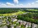 An aerial view shows a neighborhood situated near a golf course with lush greenery and blue skies at 1030 Pinehurst Ln, Fort Mill, SC 29707