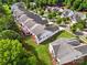 An aerial view of homes featuring expansive backyards, wooden decks, and lush green trees at 1030 Pinehurst Ln, Fort Mill, SC 29707