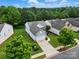 An aerial view of a home with well-maintained landscaping, a driveway, and surrounded by lush trees at 1030 Pinehurst Ln, Fort Mill, SC 29707