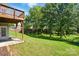 Large backyard with a lush green lawn and privacy from mature trees and natural foliage at 1030 Pinehurst Ln, Fort Mill, SC 29707