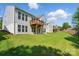 Spacious backyard featuring a well-manicured lawn and a private deck, perfect for outdoor enjoyment at 1030 Pinehurst Ln, Fort Mill, SC 29707
