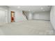 Spacious basement has neutral carpet, recessed lighting and a staircase leading upstairs at 1030 Pinehurst Ln, Fort Mill, SC 29707