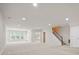 Finished basement is bright and spacious, featuring recessed lighting and a stairway to the upper floor at 1030 Pinehurst Ln, Fort Mill, SC 29707
