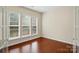 This bedroom features three bright windows and hardwood floors at 1030 Pinehurst Ln, Fort Mill, SC 29707