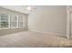 Bright bedroom with large windows, neutral carpet, and plenty of open space at 1030 Pinehurst Ln, Fort Mill, SC 29707