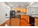 Open kitchen boasts wood cabinets, granite countertops, stainless appliances, and convenient island at 1030 Pinehurst Ln, Fort Mill, SC 29707