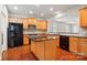 Stylish kitchen with wood cabinets, granite countertops, stainless appliances, and island with breakfast bar at 1030 Pinehurst Ln, Fort Mill, SC 29707