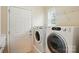 Bright laundry room with white front loading washer and dryer at 1030 Pinehurst Ln, Fort Mill, SC 29707
