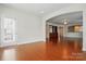 Open-concept living room with hardwood floors, archway, and natural light at 1030 Pinehurst Ln, Fort Mill, SC 29707