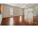 Sun-filled living room featuring hardwood floors, neutral walls, and a seamless flow to the sunroom at 1030 Pinehurst Ln, Fort Mill, SC 29707