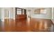 Open-concept living room showcasing hardwood floors, a built-in, and an arched entrance to the kitchen at 1030 Pinehurst Ln, Fort Mill, SC 29707