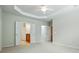 Bright main bedroom boasts tray ceiling, ceiling fan, and double doors to the en suite bathroom and walk in closet at 1030 Pinehurst Ln, Fort Mill, SC 29707