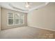 Large main bedroom features tray ceiling, carpet, and natural light at 1030 Pinehurst Ln, Fort Mill, SC 29707