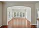 Bright sunroom filled with natural light from numerous windows, and beautiful hardwood floors at 1030 Pinehurst Ln, Fort Mill, SC 29707