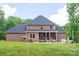Rear view of brick home with patio including seating and dining at 106 Hannaford Pl # 15, Gastonia, NC 28052