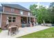 Back patio of home includes outdoor furniture and brick exterior at 106 Hannaford Pl # 15, Gastonia, NC 28052