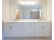 Bright bathroom featuring double sinks with modern fixtures and ample counter space, and white cabinets at 106 Hannaford Pl # 15, Gastonia, NC 28052