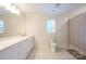 Bright bathroom featuring tile floors, a large vanity, and a shower with neutral-toned curtain at 106 Hannaford Pl # 15, Gastonia, NC 28052