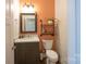 Stylish half bath with a rustic wood framed mirror, vessel sink, and modern wall accents at 106 Hannaford Pl # 15, Gastonia, NC 28052